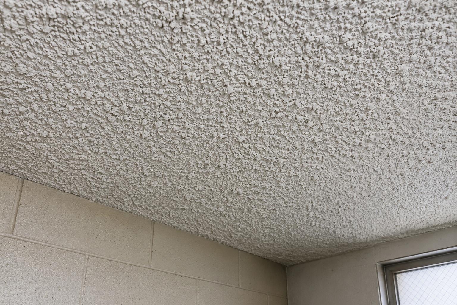 Older textured ceiling material sometimes associated with asbestos-containing products