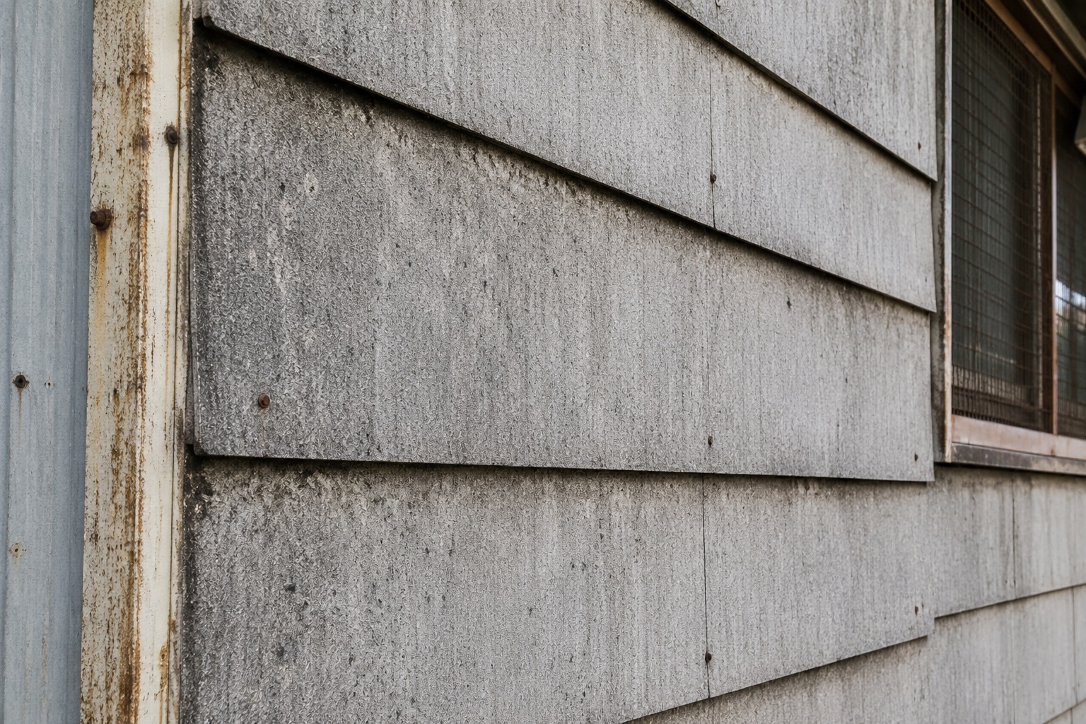 Weathered exterior transite panels on an industrial building